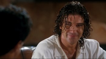 Movie still from “Assassins” (1995), directed by Richard Donner – A person wearing a white shirt; Close Up shot, Over the shoulder angle