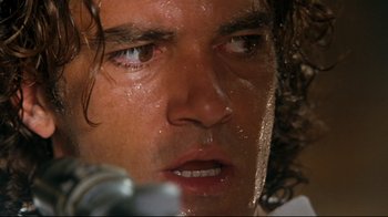 Movie still from “Assassins” (1995), directed by Richard Donner – A person's face with water on them; Extreme Close Up shot, Low angle