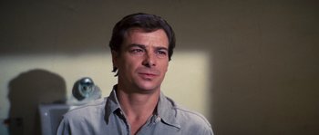 Movie still from “Assault on Precinct 13” (1976), directed by John Carpenter – A person wearing a blue shirt; Close Up shot, Over the shoulder angle