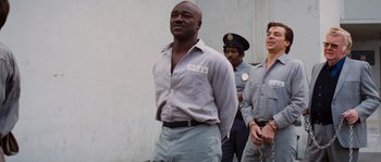 Movie still from “Assault on Precinct 13” (1976), directed by John Carpenter – A group of men standing next to each other; Medium shot, Low angle