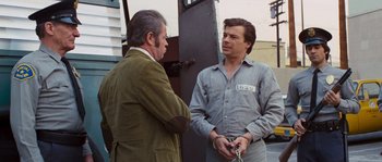 Movie still from “Assault on Precinct 13” (1976), directed by John Carpenter – Two men are standing outside talking to each other; Medium shot, Over the shoulder angle