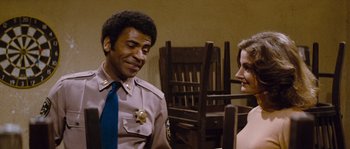 Movie still from “Assault on Precinct 13” (1976), directed by John Carpenter – A man and a woman talking to each other; Medium shot, Over the shoulder angle