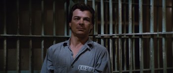 Movie still from “Assault on Precinct 13” (1976), directed by John Carpenter – A man standing in front of a jail cell; Close Up shot, High angle