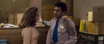 Movie still from “Assault on Precinct 13” (1976), directed by John Carpenter – A man and a woman are talking to each other; Medium shot, Over the shoulder angle