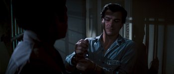 Movie still from “Assault on Precinct 13” (1976), directed by John Carpenter – A man holding a pair of scissors in his hand; Medium shot, High angle