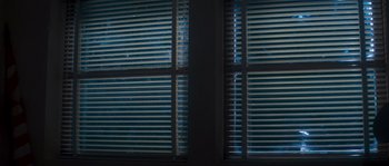 Movie still from “Assault on Precinct 13” (1976), directed by John Carpenter – A view of a window with blinds closed on the outside of the window; Extreme Close Up shot, Low angle