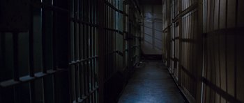 Movie still from “Assault on Precinct 13” (1976), directed by John Carpenter – A long hallway with a bunch of bars on the wall; Extreme Wide shot, High angle