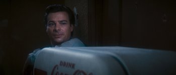 Movie still from “Assault on Precinct 13” (1976), directed by John Carpenter – A man sitting in front of an open coke can; Close Up shot, Low angle