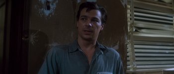 Movie still from “Assault on Precinct 13” (1976), directed by John Carpenter – A man in a blue shirt is looking at the camera; Close Up shot, Low angle