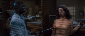 Movie still from “Assault on Precinct 13” (1976), directed by John Carpenter – A man and a woman in a room; Medium shot, Over the shoulder angle
