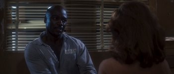 Movie still from “Assault on Precinct 13” (1976), directed by John Carpenter – A man and a woman are talking to each other; Medium shot, Over the shoulder angle