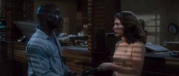 Movie still from “Assault on Precinct 13” (1976), directed by John Carpenter – A man and a woman talking to each other in a room; Medium shot, Over the shoulder angle