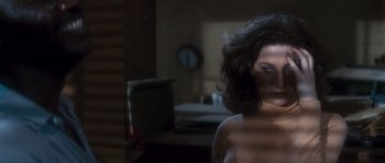 Movie still from “Assault on Precinct 13” (1976), directed by John Carpenter – A woman standing in front of a mirror in a dark room; Close Up shot, Low angle