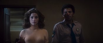 Movie still from “Assault on Precinct 13” (1976), directed by John Carpenter – A man and a woman standing next to each other in a room; Medium shot, Low angle