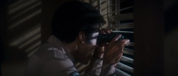 Movie still from “Assault on Precinct 13” (1976), directed by John Carpenter – A man taking a picture with a cell phone; Close Up shot, Low angle