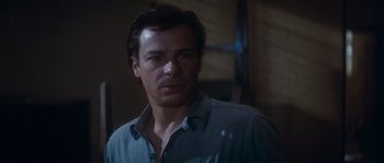 Movie still from “Assault on Precinct 13” (1976), directed by John Carpenter – A person wearing a blue shirt; Close Up shot, Over the shoulder angle