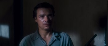 Movie still from “Assault on Precinct 13” (1976), directed by John Carpenter – A person wearing a blue shirt; Close Up shot, High angle