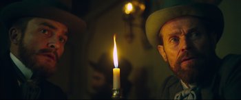 Movie still from “At Eternity's Gate” (2018), directed by Julian Schnabel – A man with a hat and a candle in the middle of a room; Close Up shot, Over the shoulder angle
