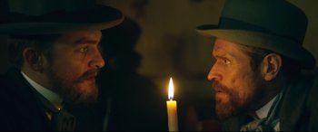 Movie still from “At Eternity's Gate” (2018), directed by Julian Schnabel – Two men are looking at a candle in the dark; Close Up shot, Over the shoulder angle