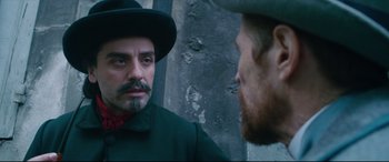 Movie still from “At Eternity's Gate” (2018), directed by Julian Schnabel – A man wearing a hat looking at himself in the mirror; Close Up shot, Over the shoulder angle