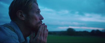 Movie still from “At Eternity's Gate” (2018), directed by Julian Schnabel – A person with their hands clasped in prayer; Close Up shot, Low angle