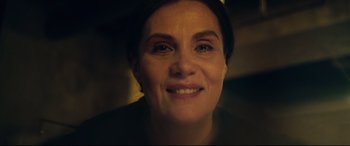 Movie still from “At Eternity's Gate” (2018), directed by Julian Schnabel – A woman smiling for the camera; Close Up shot, High angle