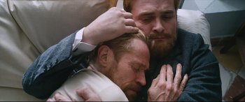 Movie still from “At Eternity's Gate” (2018), directed by Julian Schnabel – Two men with their hands on each other's shoulders; Close Up shot, High angle