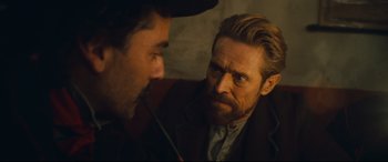 Movie still from “At Eternity's Gate” (2018), directed by Julian Schnabel – A man with long hair and a beard is talking to another man with long hair and a beard; Close Up shot, Over the shoulder angle