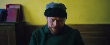 Movie still from “At Eternity's Gate” (2018), directed by Julian Schnabel – A man with a beard wearing a hat; Close Up shot, Low angle