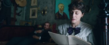 Movie still from “At Eternity's Gate” (2018), directed by Julian Schnabel – A man and a woman sitting in a living room reading; Medium shot, Over the shoulder angle