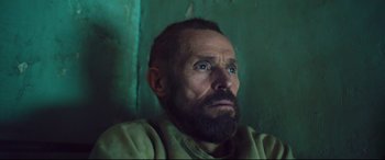 Movie still from “At Eternity's Gate” (2018), directed by Julian Schnabel – A man with a goatee and a beard looking upward; Close Up shot, Low angle