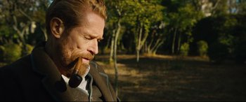 Movie still from “At Eternity's Gate” (2018), directed by Julian Schnabel – A person with a beard smoking a pipe; Close Up shot, Over the shoulder angle