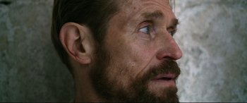 Movie still from “At Eternity's Gate” (2018), directed by Julian Schnabel – A person with a beard and blue eyes; Close Up shot, Low angle