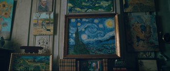 Movie still from “At Eternity's Gate” (2018), directed by Julian Schnabel – A painting of a starry night is on display in a room; Medium shot, Overhead angle