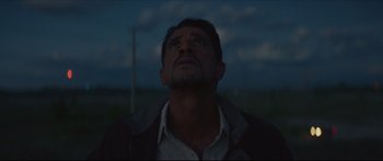 Movie still from “At First Light” (2018), directed by Jason Stone – A person looking up at the sky; Close Up shot, Low angle