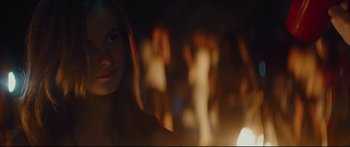 Movie still from “At First Light” (2018), directed by Jason Stone – A woman standing in front of a group of naked women; Close Up shot, Over the shoulder angle
