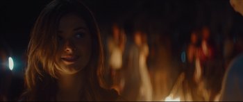 Movie still from “At First Light” (2018), directed by Jason Stone – A woman is looking at the camera in the dark; Close Up shot, Over the shoulder angle