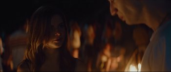 Movie still from “At First Light” (2018), directed by Jason Stone – A woman standing in front of a group of people; Close Up shot, Over the shoulder angle