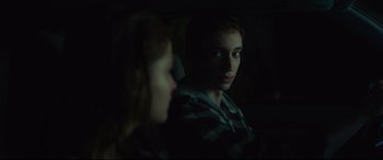 Movie still from “At First Light” (2018), directed by Jason Stone – A boy and a girl looking at each other in the dark; Close Up shot, Over the shoulder angle