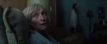Movie still from “At First Light” (2018), directed by Jason Stone – An older woman with blue eyes stares into the camera; Close Up shot, Over the shoulder angle