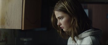 Movie still from “At First Light” (2018), directed by Jason Stone – A woman with long hair is looking at a computer screen; Close Up shot, Over the shoulder angle