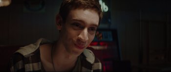 Movie still from “At First Light” (2018), directed by Jason Stone – A person smiling for the camera; Close Up shot, Over the shoulder angle
