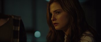 Movie still from “At First Light” (2018), directed by Jason Stone – A person with long red hair; Close Up shot, Over the shoulder angle