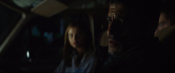 Movie still from “At First Light” (2018), directed by Jason Stone – A man and a woman sitting in a car; Close Up shot, Over the shoulder angle