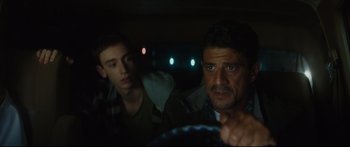 Movie still from “At First Light” (2018), directed by Jason Stone – A man and a boy sitting in a car at night; Close Up shot, Over the shoulder angle