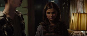Movie still from “At First Light” (2018), directed by Jason Stone – A young girl is standing in the dark; Close Up shot, Over the shoulder angle