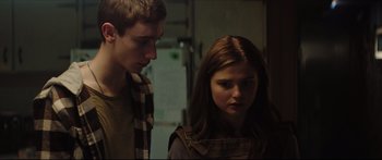 Movie still from “At First Light” (2018), directed by Jason Stone – A man and a woman standing next to each other; Close Up shot, Over the shoulder angle