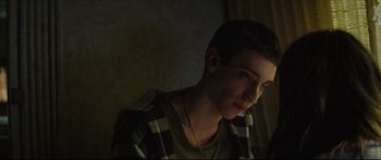 Movie still from “At First Light” (2018), directed by Jason Stone – A young man is sitting in the dark; Close Up shot, Over the shoulder angle