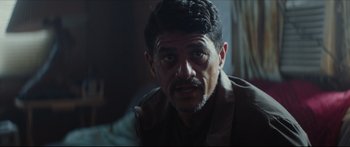 Movie still from “At First Light” (2018), directed by Jason Stone – A person with a beard looking at the camera; Close Up shot, Over the shoulder angle