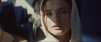 Movie still from “At First Light” (2018), directed by Jason Stone – A person wearing a hooded jacket; Close Up shot, Over the shoulder angle